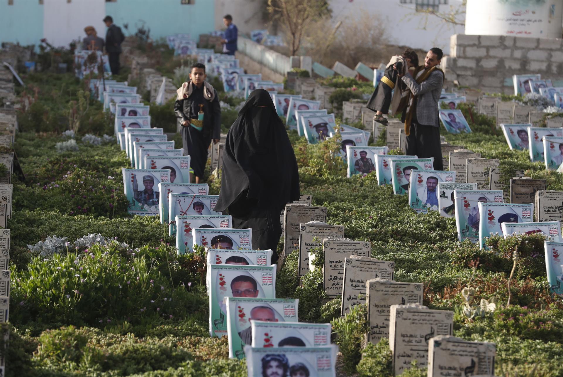 Iemenites caminen per un cementir durant el primer dia de les celebracions d'Eid Al-Fitr, el festival de tres dies que marca el final de Ramadà, a Sana'a el 2 de maig. Fotografia: EFE/EPA/Yahya Arhab