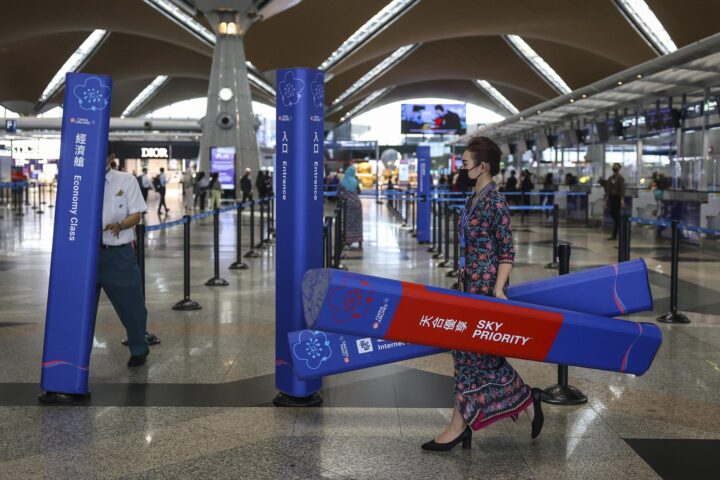 Treballadors d'Air China preparen l'espai de facturació de la companyia a l'aeroport de Kuala Lumpur pels vols que es reprendran avui (fotografia: Frazy Ismail).
