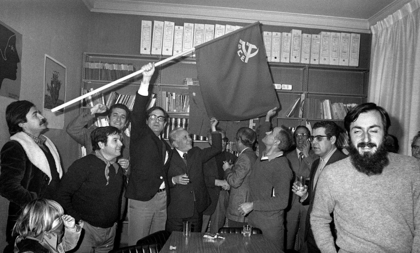 Ramón Tamames enarborant la bandera del Partit Comunista (fotografia: agència EFE).
