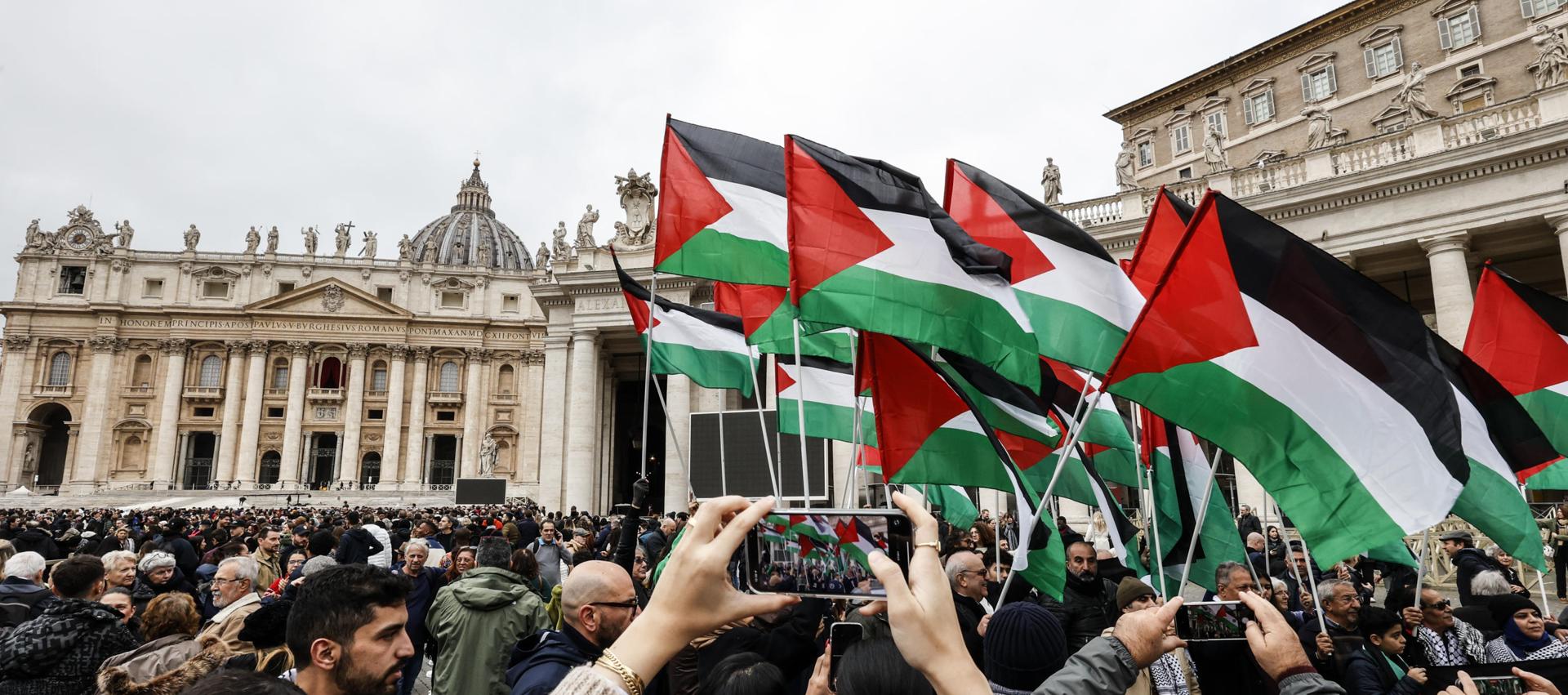 Un grup de persones enarbora banderes palestines davant el Papa, durant la celebració de Nadal. (Fotografia de Fabio Frustadi)