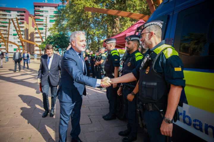 El batlle de Barcelona, Jaume Collboni, estreny la mà d'un agent de la Guàrdia Urbana, en una imatge d'arxiu.