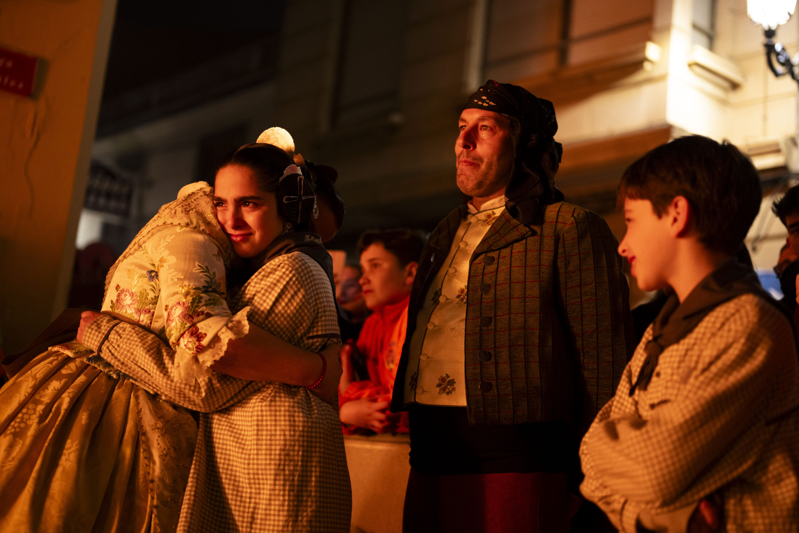 La fallera major de la Falla Cervantes de Paiporta consola a la fallera infantil durant la Cremà.