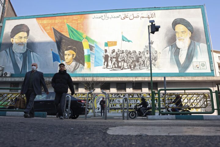 Dos vianants passen per davant d'un mural amb el rostre del líder suprem de l'Iran, l'aiatol·là Ali Khamenei, en un carrer de Teheran, la capital del país, aquesta setmana (fotografia: Abedin Taherkenareh/Efe).